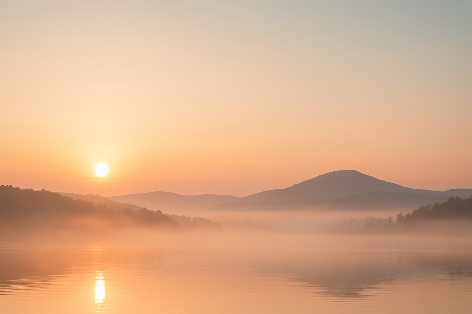 A peaceful sunrise over a misty lake